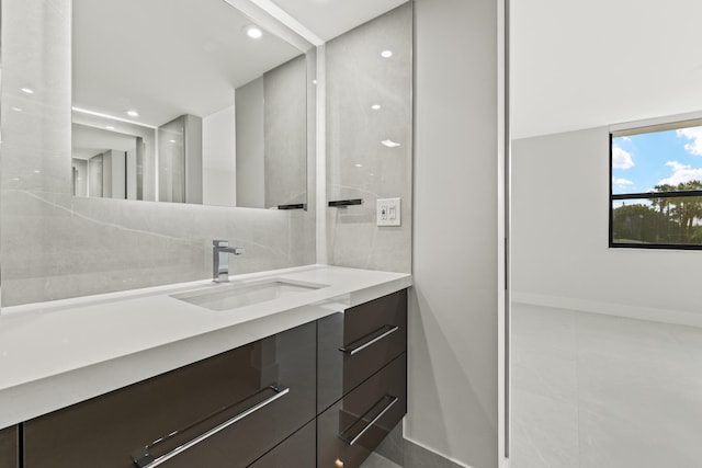 bathroom featuring recessed lighting and vanity