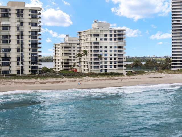 view of pool featuring a view of the beach and a water view