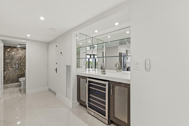 kitchen with a center island, white cabinets, wall chimney exhaust hood, dark brown cabinetry, and stainless steel appliances