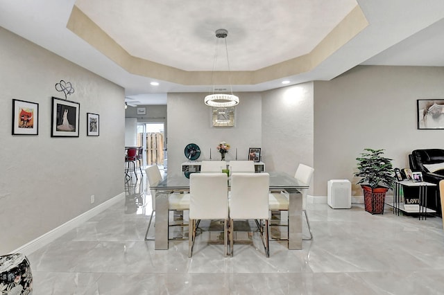 dining room with a tray ceiling and ceiling fan