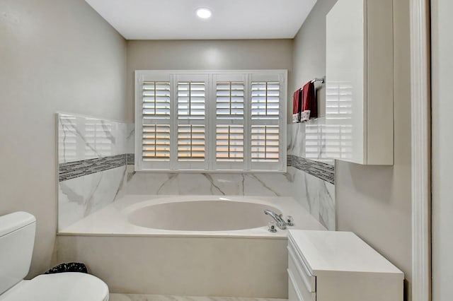 bathroom featuring a tub and toilet