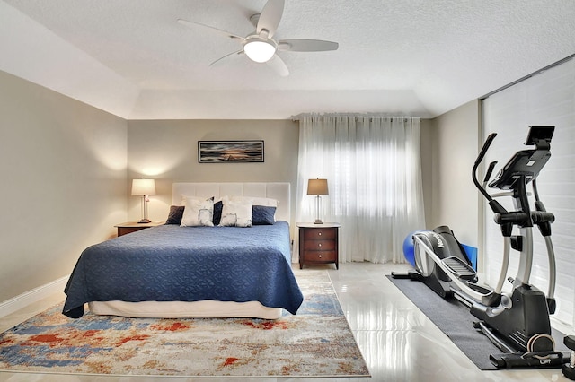 bedroom featuring ceiling fan and a textured ceiling