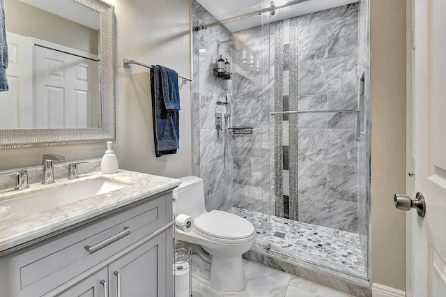 bathroom featuring vanity, toilet, and a shower with door