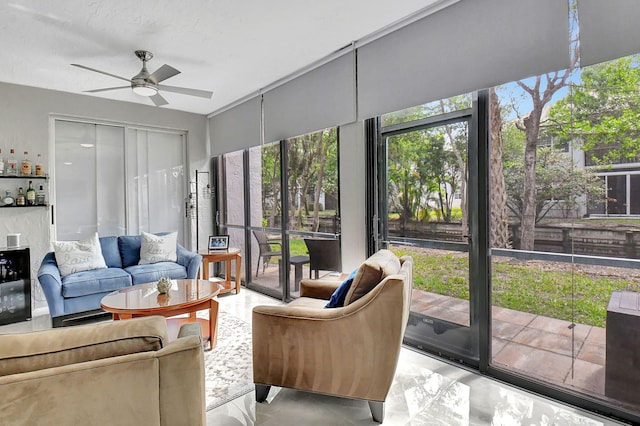 sunroom / solarium featuring ceiling fan