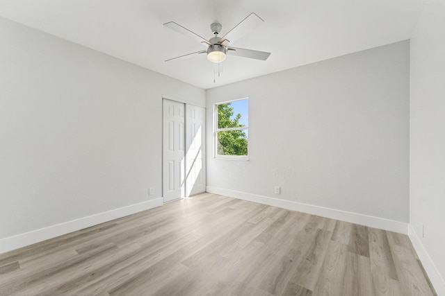 empty room featuring ceiling fan and light hardwood / wood-style floors