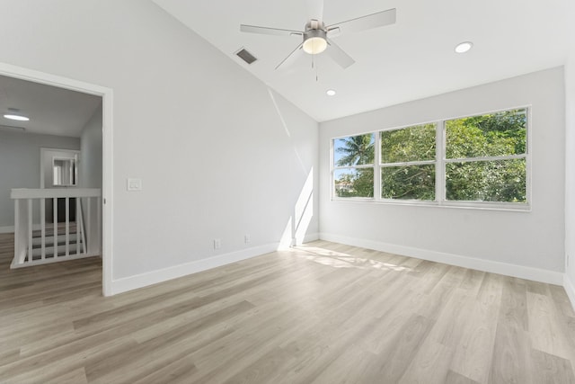 empty room with light hardwood / wood-style floors, vaulted ceiling, and ceiling fan