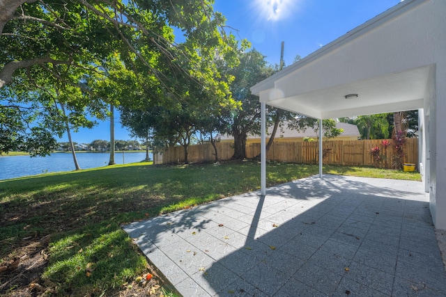 view of yard with a patio area and a water view