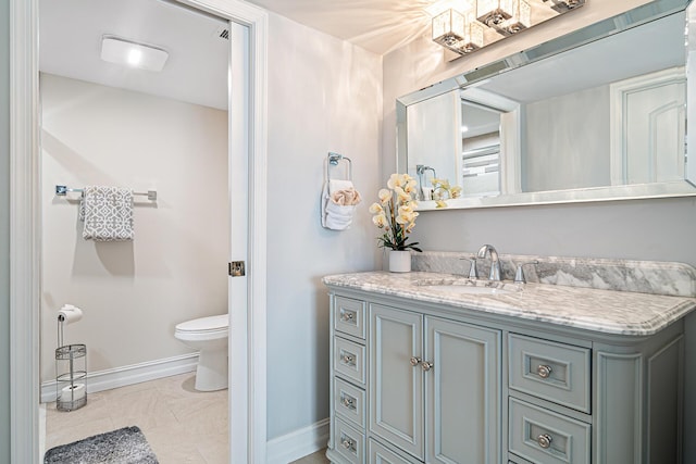 bathroom featuring tile patterned flooring, vanity, and toilet