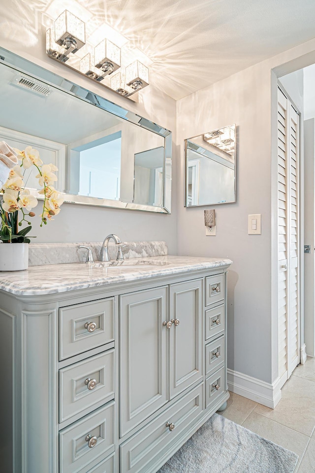 bathroom with tile patterned flooring and vanity