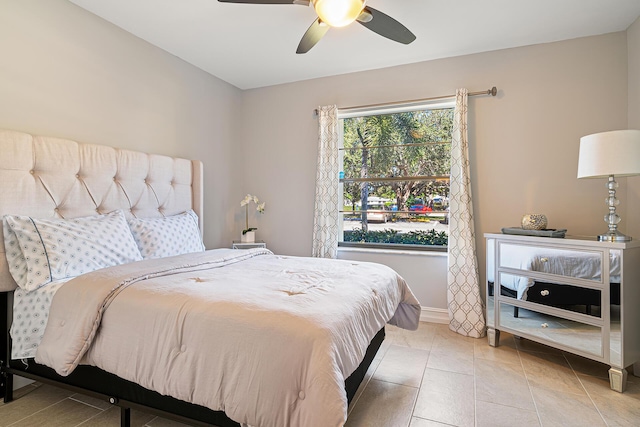 bedroom with ceiling fan and light tile patterned floors