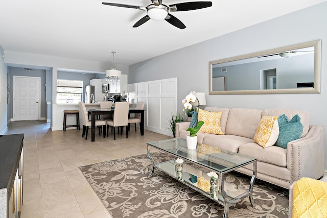 living room with ceiling fan and light tile patterned flooring