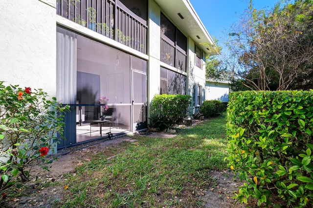 view of side of property with a patio area and a yard