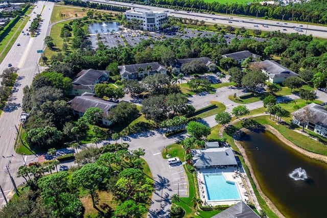 birds eye view of property with a water view