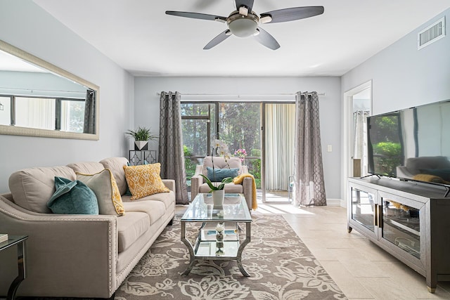 living room featuring a wealth of natural light and ceiling fan