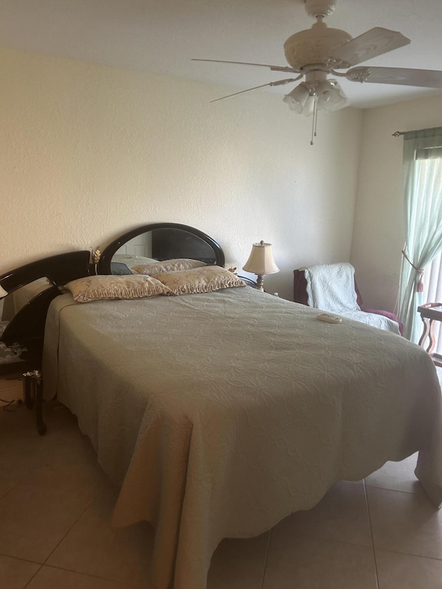 tiled bedroom with ceiling fan