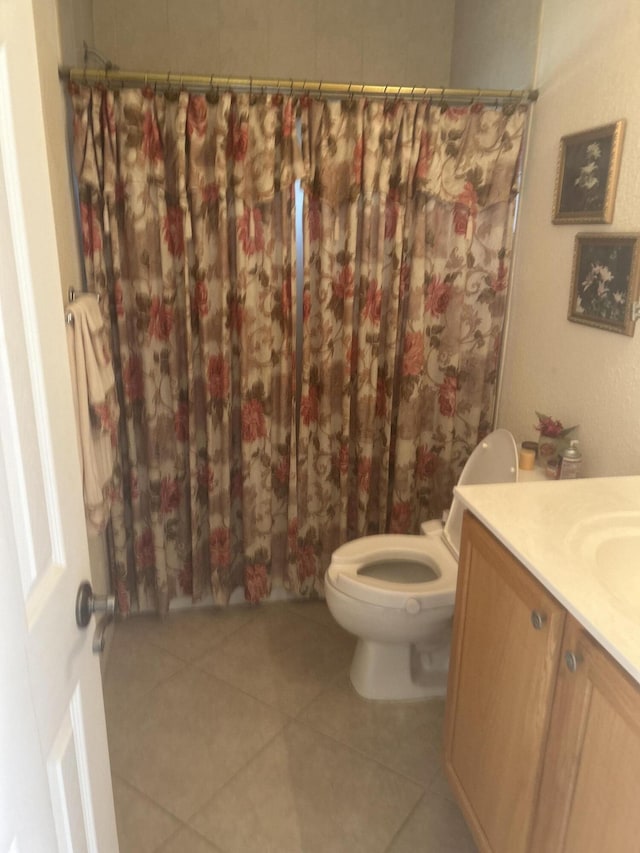 bathroom featuring tile patterned floors, vanity, and toilet