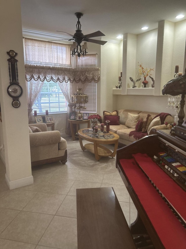 living room featuring tile patterned flooring, ceiling fan, and crown molding