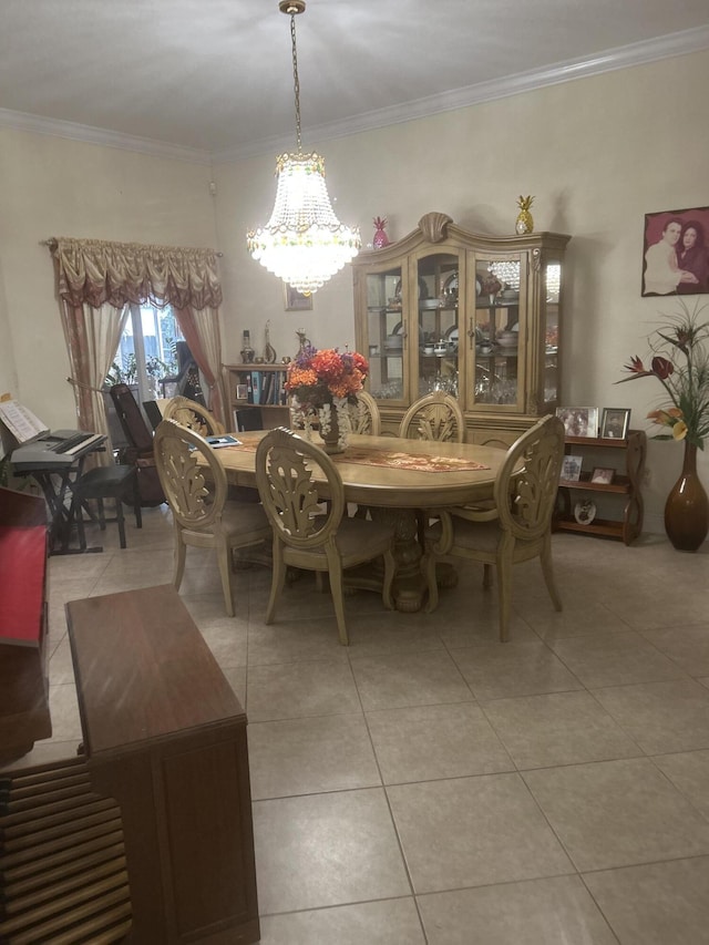 dining space with ornamental molding, light tile patterned floors, and a chandelier