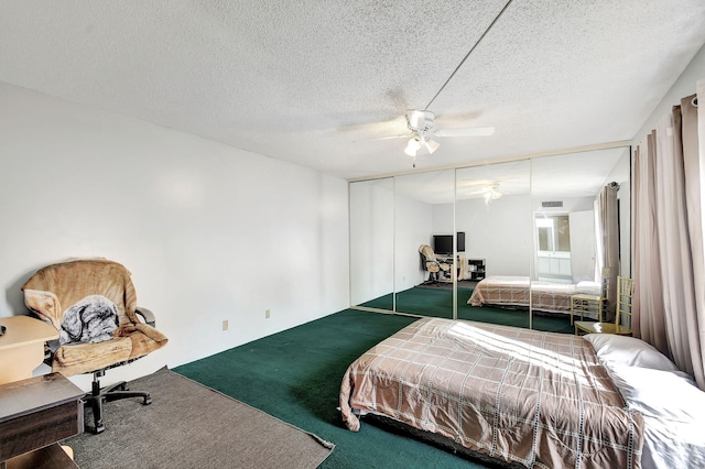 carpeted bedroom featuring a textured ceiling, a closet, and ceiling fan