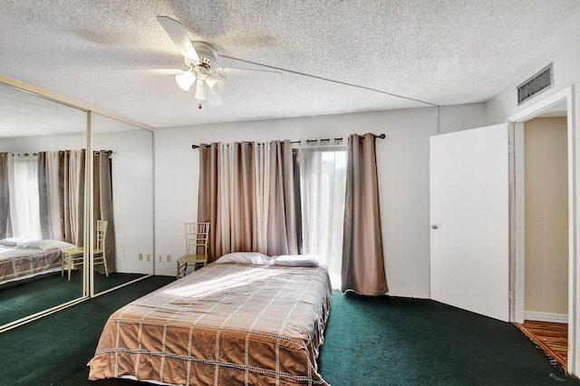 bedroom featuring ceiling fan, a closet, and dark carpet