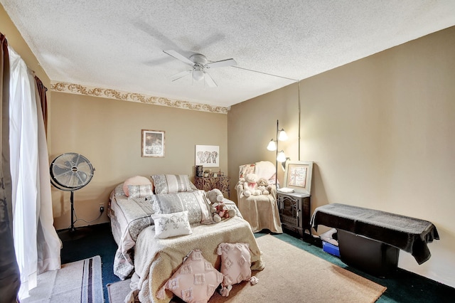 carpeted bedroom featuring ceiling fan and a textured ceiling