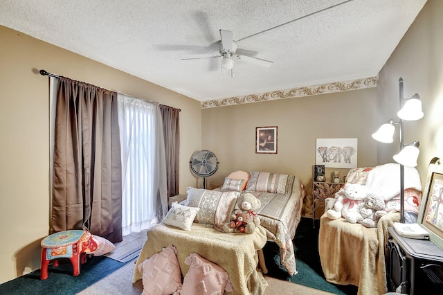 carpeted bedroom with ceiling fan and a textured ceiling