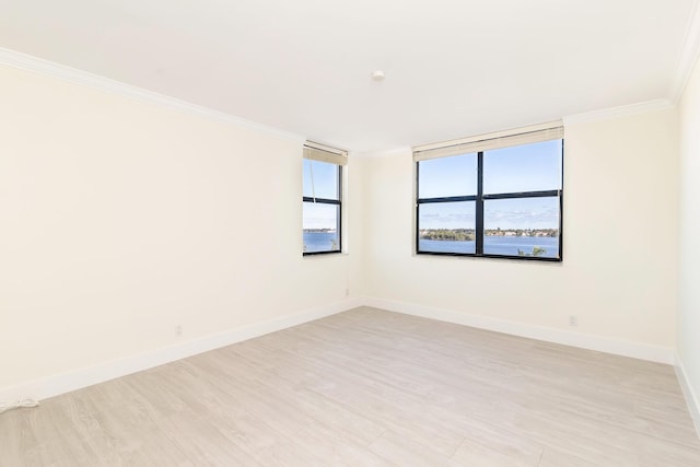 unfurnished room with crown molding and light hardwood / wood-style floors