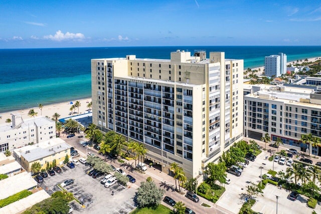 drone / aerial view with a beach view and a water view