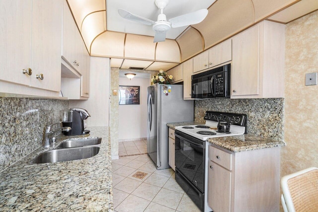 kitchen with ceiling fan, sink, light stone counters, light tile patterned flooring, and black appliances