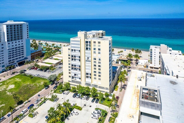 drone / aerial view featuring a water view and a beach view