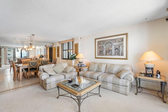 carpeted living room with a textured ceiling and a notable chandelier