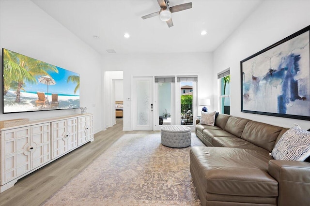 living room featuring ceiling fan and light hardwood / wood-style floors