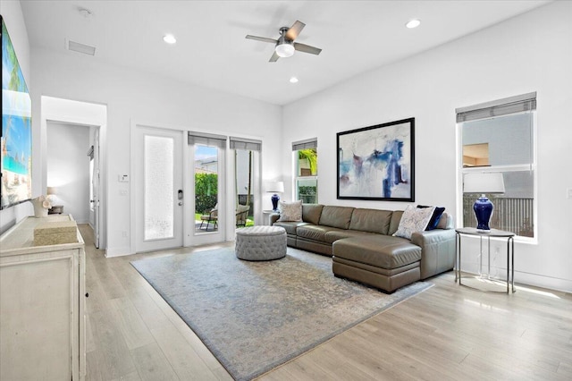 living room featuring ceiling fan and light hardwood / wood-style flooring