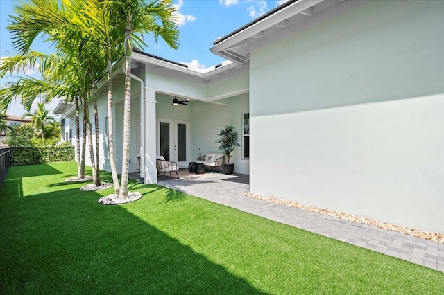 view of yard with french doors and a patio