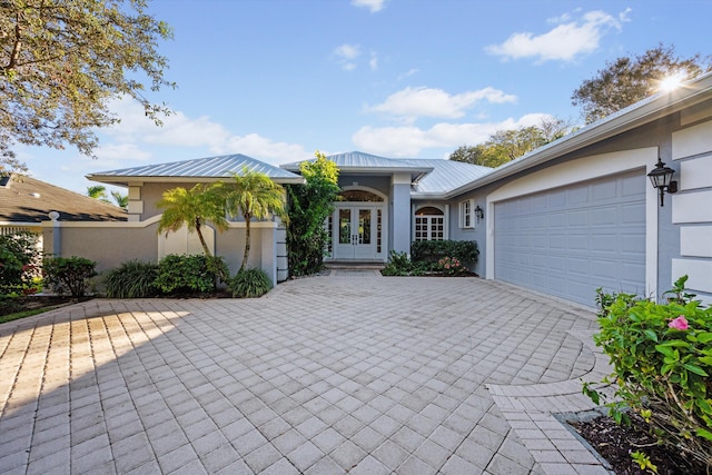 ranch-style house with a garage and french doors