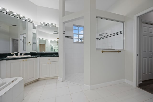 bathroom featuring tile patterned flooring, vanity, and shower with separate bathtub