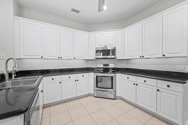 kitchen featuring white cabinets, light tile patterned floors, sink, and appliances with stainless steel finishes