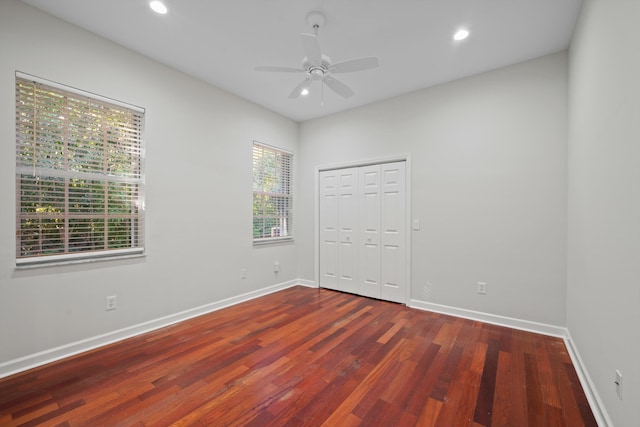 spare room with ceiling fan and dark hardwood / wood-style floors