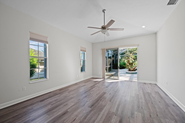 spare room with hardwood / wood-style floors, ceiling fan, and a wealth of natural light