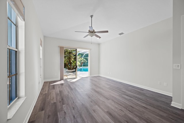 spare room featuring ceiling fan, dark hardwood / wood-style flooring, and lofted ceiling