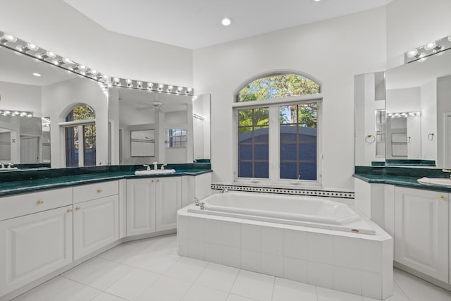 bathroom featuring french doors, tile patterned floors, vanity, ceiling fan, and tiled bath