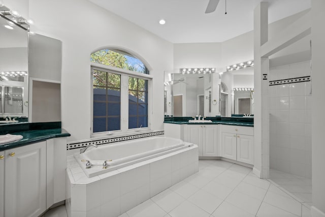 bathroom featuring tile patterned floors, vanity, ceiling fan, and plus walk in shower