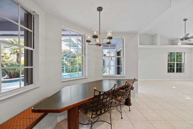 dining space with ceiling fan with notable chandelier and light tile patterned floors