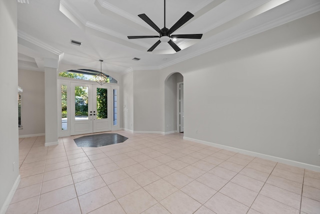 tiled foyer entrance with a raised ceiling, ceiling fan, french doors, and ornamental molding