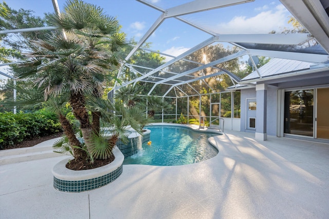 view of swimming pool featuring a lanai and a patio area