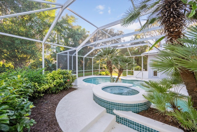 view of swimming pool with an in ground hot tub and a lanai