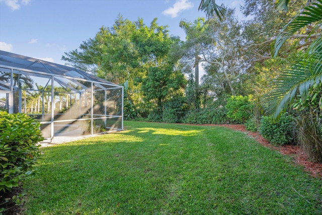 view of yard featuring glass enclosure