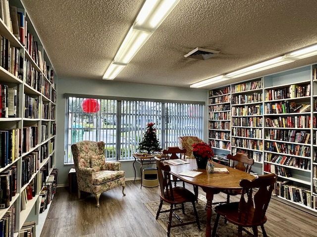 interior space with hardwood / wood-style flooring and a textured ceiling