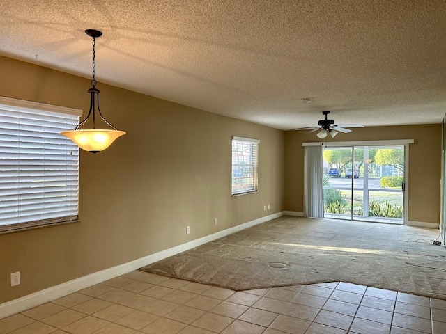 spare room with ceiling fan, carpet floors, and a textured ceiling