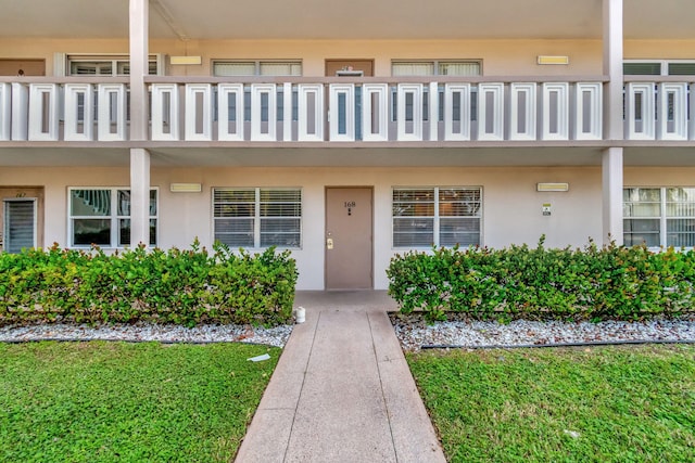 entrance to property featuring a yard